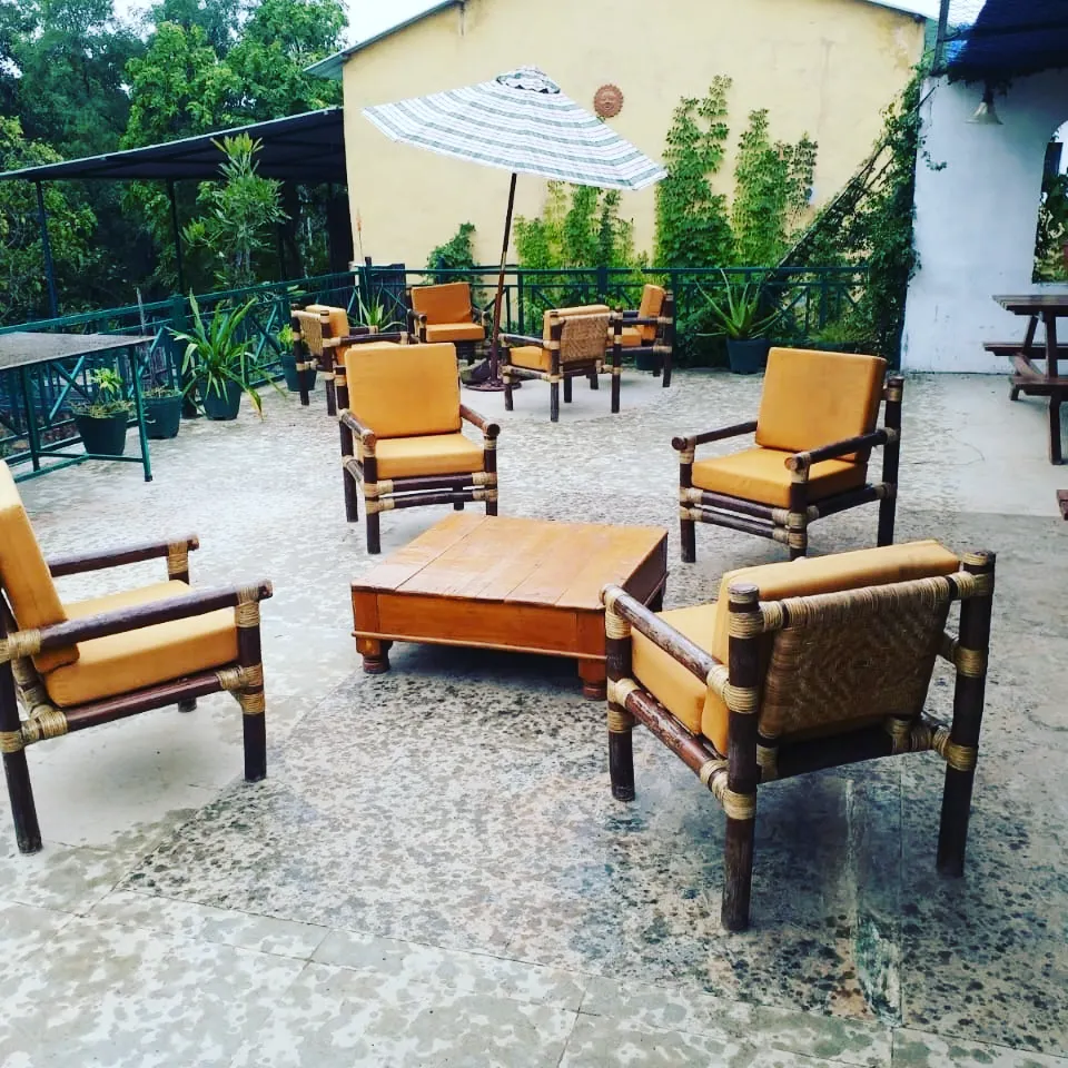 Outdoor dining terrace with cane chairs and wooden tables