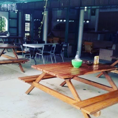 Long wooden dining tables in the open pavilion