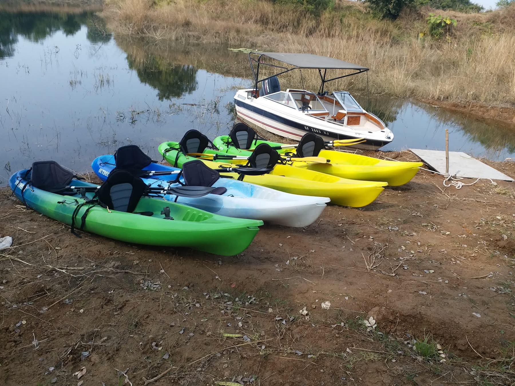 Kayaks drawn up on the shore of the reservoir