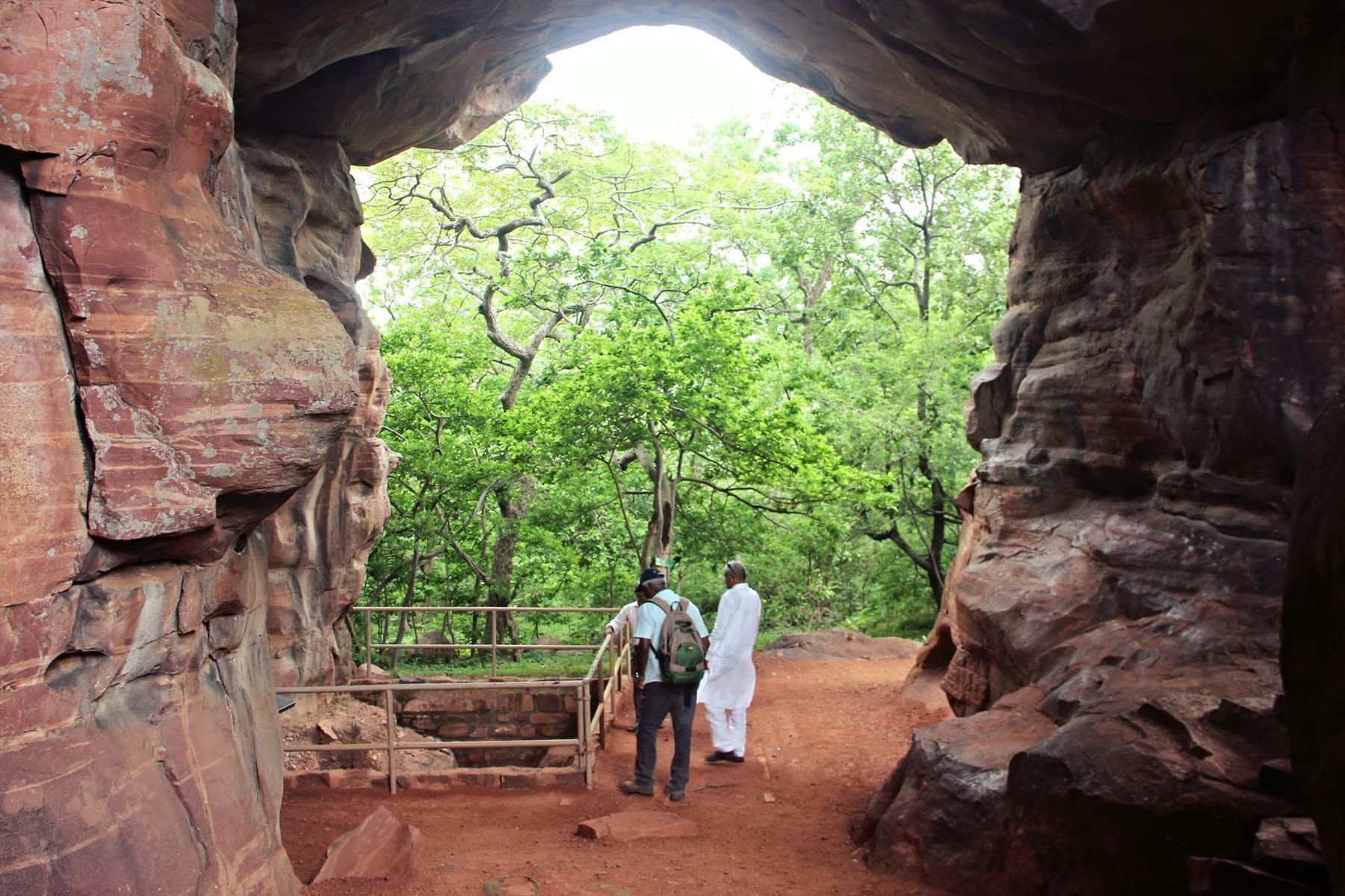 Natural sandstone arch framing the forest beyond
